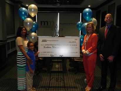 Meyerkord & Kurth presents a check to United Brachial Plexus Network for summer camp