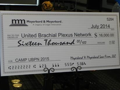 Meyerkord & Kurth presents a check to United Brachial Plexus Network for summer camp