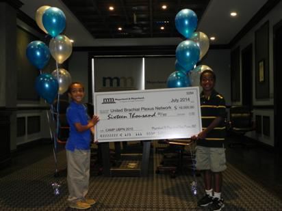 Meyerkord & Kurth presents a check to United Brachial Plexus Network for summer camp