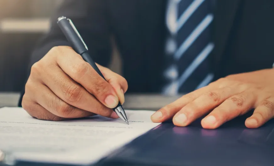 St. Louis personal injury lawyer signing a document
